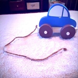 wooden little blue pull toy. blue car